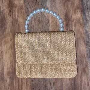 woven handbag with pearl handle